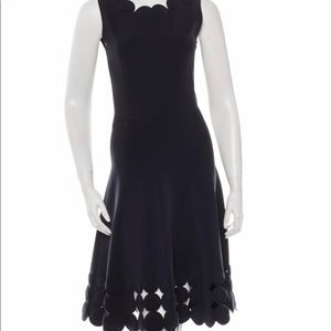 Black Oscar de la Renta neoprene dress with circular details at neck . Size da